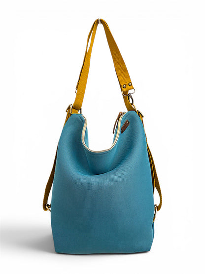 bolso convertible en mochila realizado de forma artesanal en Barcelona 3 en 1, mochila, tote bag o bandolera. Color azul y correas mostaza.