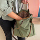 Bolso hecho a mano de tejido tipo loneta color verde militar con forro y bolsillo  interior. Un modelo super cómodo y funcional porque lo puedes llevar de mano, tipo bandolera o colgado al hombro.   Las asas son de cuero regulable color marrón con mosquetones que puedes ponerlo a 2 alturas según la capacidad que necesites del bolso. Cierre con cremallera.  Este bolso tiene 2 opciones bandolera o Tote bag. Lleva un llavero que se puede colgar dentro de regalo para tener siempre tus llaves a mano.